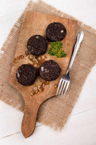 istock fried black pudding with onion and parsley on wooden board 897950906