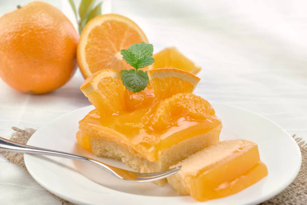 istock Orange cake on a white table with fresh orange. 897951400