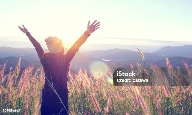 Happy Woman Enjoying Nature On Meadow On Top Of Mountain With Sunrise Outdoor Freedom Concept Stock Photo - Download Image Now