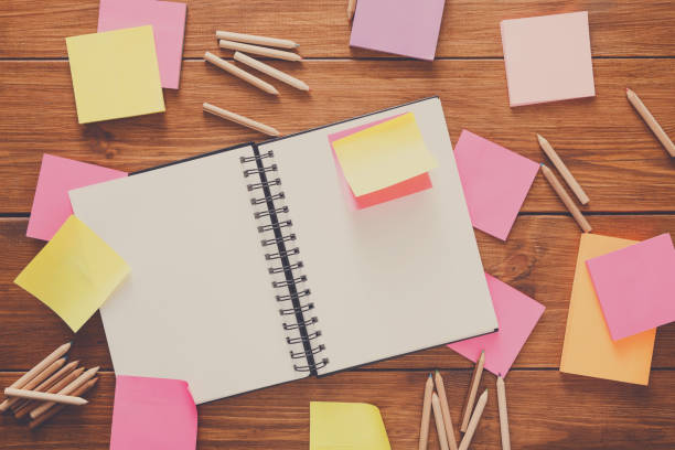 istock Top view of blank notepad on wooden office desk 897955040