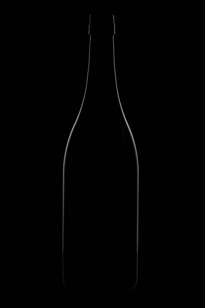 istock Wine glass and bottle on black background with rim lighting 897957738