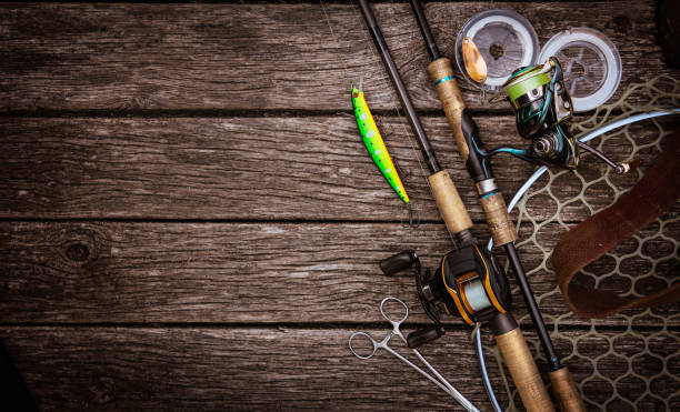 Fishing tackle background. Fishing design elements. Fishing accessories on the wooden table. Elements for advertising Fishing stock pictures, royalty-free photos & images