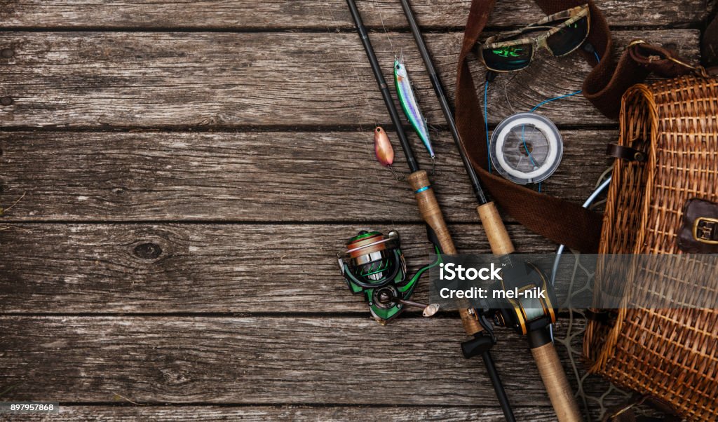 Fishing tackle background. Fishing design elements. Fishing accessories on the wooden table. Elements for advertising Fishing Stock Photo