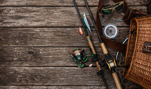 Fishing tackle background. Fishing design elements. Fishing accessories on the wooden table. Elements for advertising fishing gear stock pictures, royalty-free photos & images