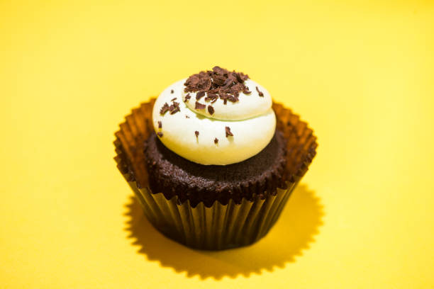 istock Birthday cupcake against a yellow background 897958654