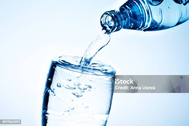 Fresh Drinking Water Is Poured In A Glass Stock Photo - Download Image Now - Water, Men, Black Color
