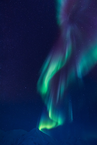 The polar arctic Northern lights aurora borealis sky star in Norway Svalbard in Longyearbyen city the moon mountains