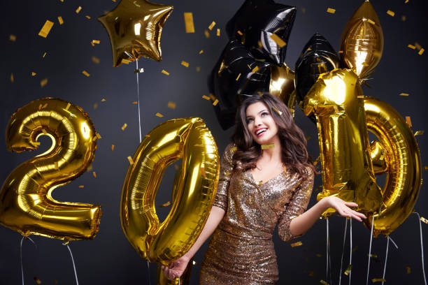 istock Happy woman with new year's balloon dancing 897966490