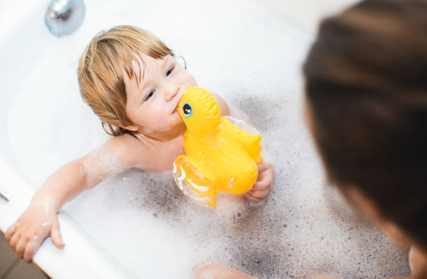 istock Baby Boy Playing in Bathtub With Parent 897972522