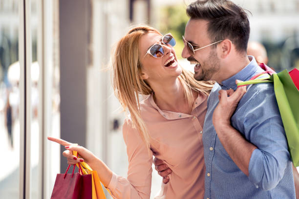 istock Beautiful young couple enjoying in shopping 897976374