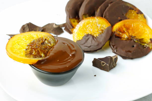 istock Candied orange slices in chocolate on white background.close up. 897982602