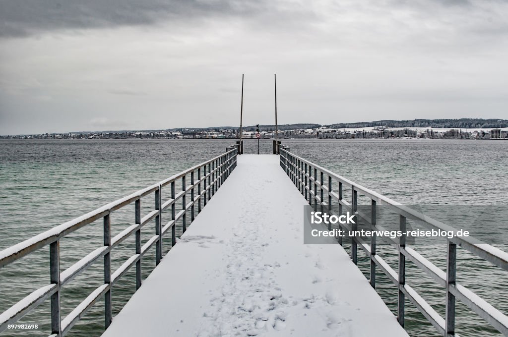 Bridge at lake in winter Bridge at lake in winter with snow on it Beach Stock Photo