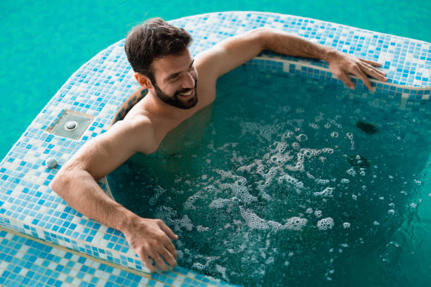 istock Attractive man enjoying spending time in hot tub 897983372