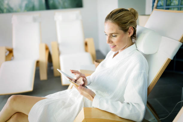 istock Beautiful woman relaxing and using tablet in spa 897983598