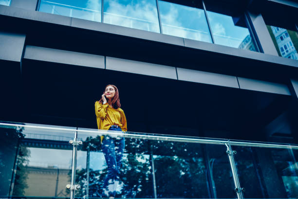 istock Positive attractive female student dressed in trendy outfit communicating with friends using application on smartphone.Charming young hipster girl looking away while contacting via modern device 897987960