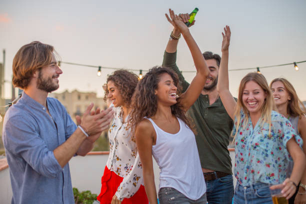 istock Group of friends dancing on rooftop 897997854