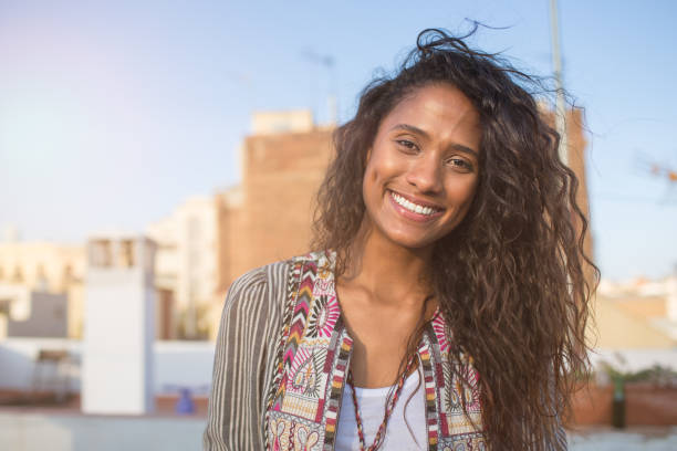istock Pretty curly haired lady on rooftop terrace 897997868