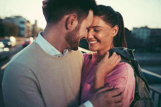 istock Young couple in love embracing on a bridge 897998610
