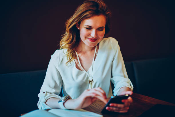 istock Smiling female happy getting message from friend texting feedback during work break in cafe,cheerful cute woman satisfied with installing new application on modern smartphone using internet connection 898001946