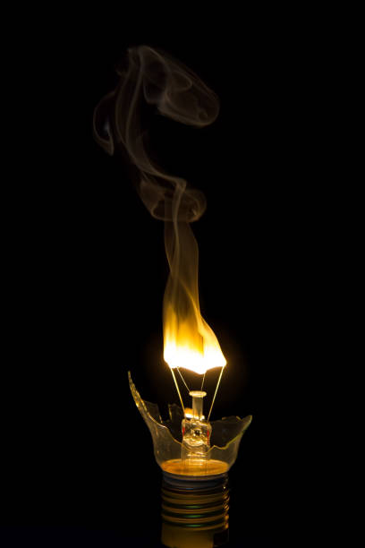 istock Broken light bulb burn out with flame on filament with smoke 898007408