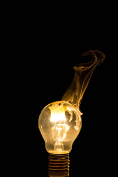 istock Broken light bulb burn out with flame on filament with smoke 898010040