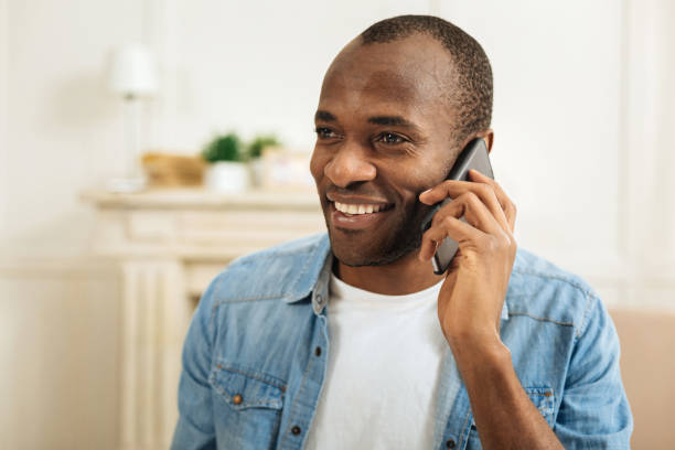 istock Happy smiling man talking on the phone 898010066