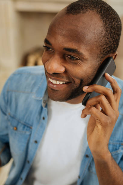 istock Exuberant smiling man talking on the phone 898010236