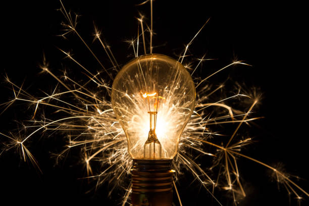 Light bulb with sparkles from behind fireworks and glowing - fotografia de stock