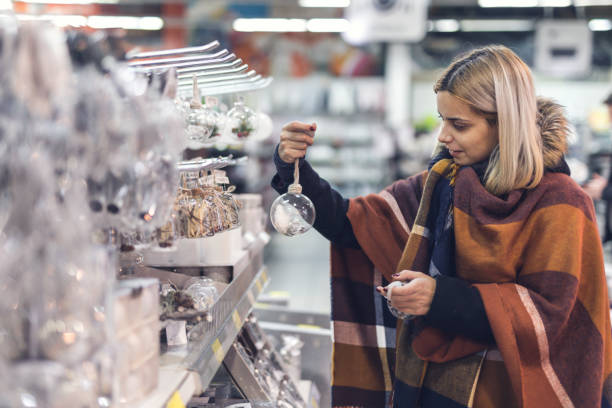 Charming lady holding decor for Christmas tree