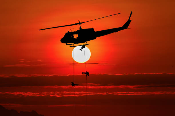 silhouette of helicoptor rescue at sunset.