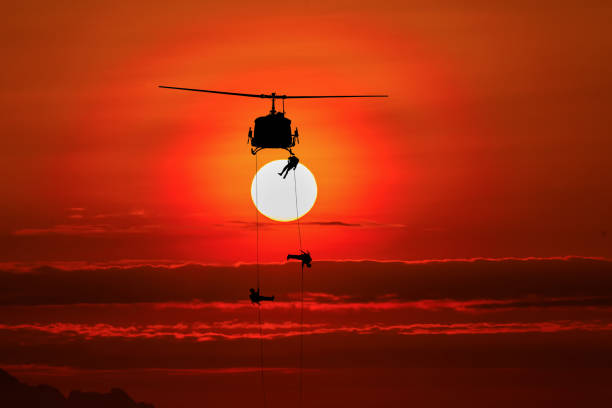 istock silhouette of helicoptor rescue at sunset. 898015030