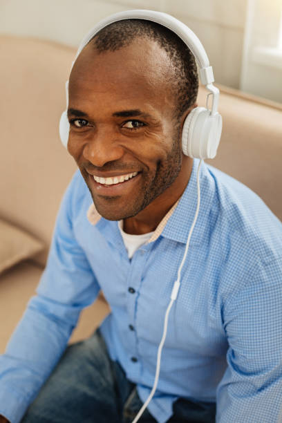 istock Beaming man listening to music 898021798