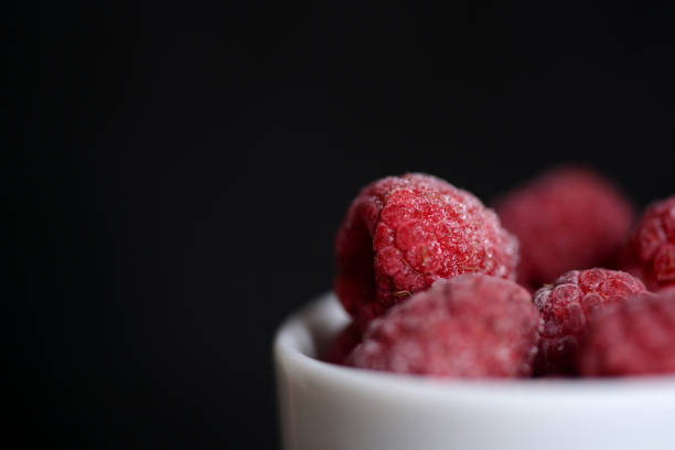 istock Frozen berries of raspberries on a dark background close up 898032198