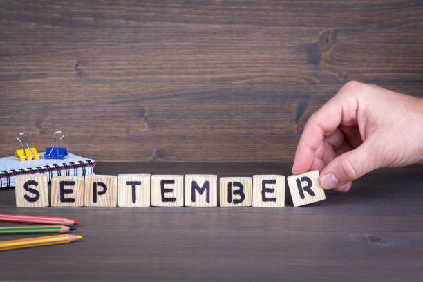 istock september. Wooden letters on the office desk, informative and communication background 898032668