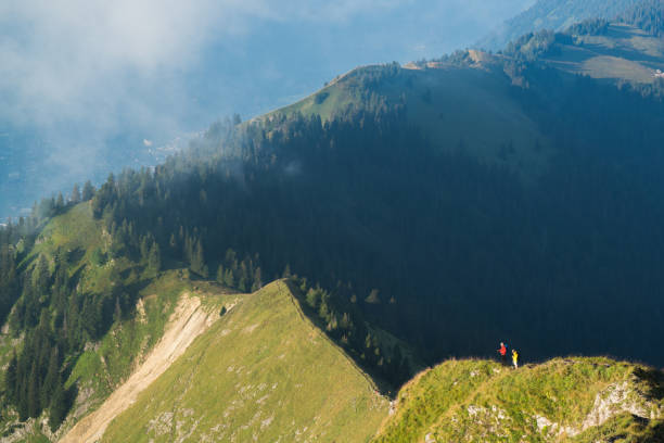 As the sun warms the ground, clouds start to rise up over the mountain ridge line