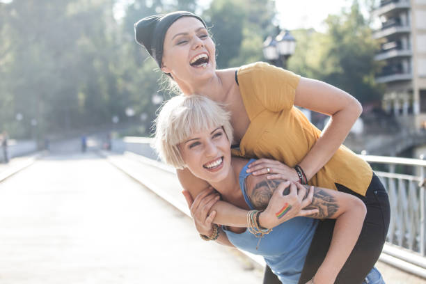 istock Couple having fun in piggyback ride on bridge 898046790