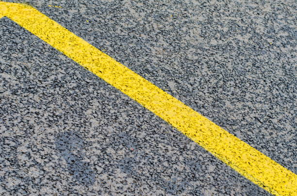 istock Fresh asphalt as abstract background and yellow road markings 898049198