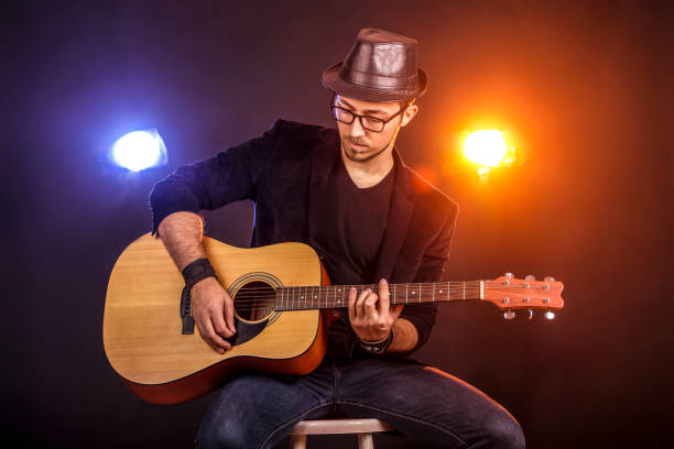 istock Young man playing acoustic guitar 898049718