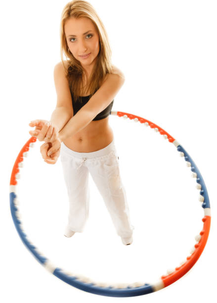 istock sporty fit girl doing exercise with hula hoop. 898056520