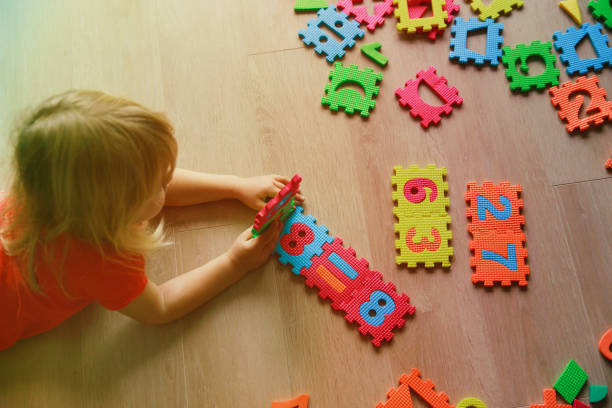 istock little girl learning numbers, education concept 898057176