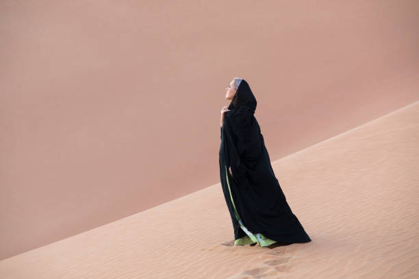 istock woman in an abaya in a desert 898063018