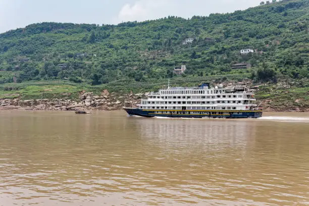 Cruise ship sailing up the Yangtze River on a hazy morning.