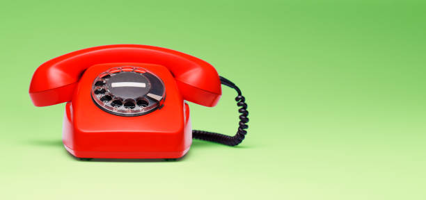 istock Red telephone in retro style on green background. 898063506