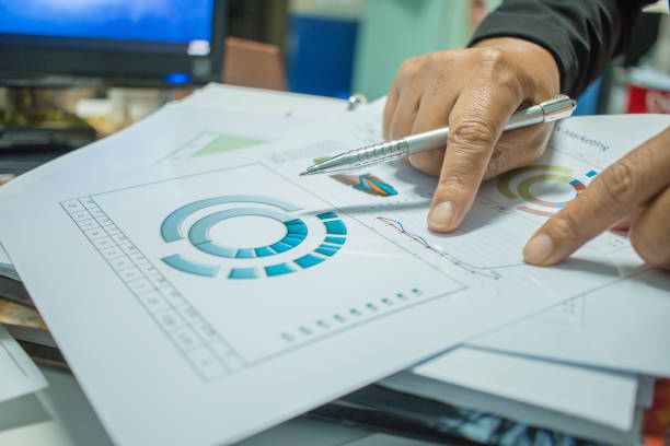 istock Businessman Preparing reports papers with graphs, charts on Stacks of documents files for finance in office. Piles of unfinished document achieves with paper clip. Concept of Business Annual Report. 898066104