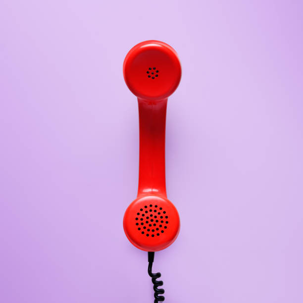 istock Red telephone in retro style on purple background. 898066106