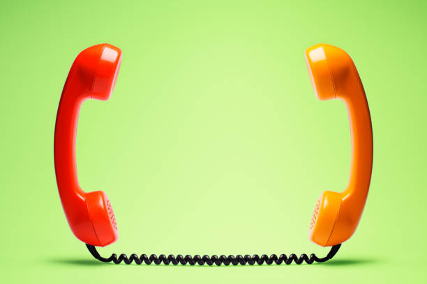 istock Red and orange telephone on blue background. 898066300