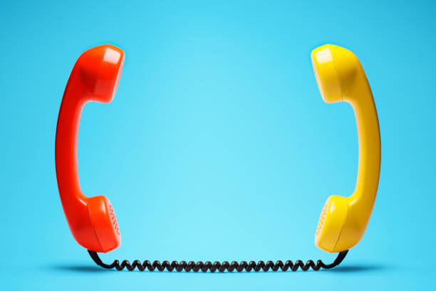 istock Red and yellow telephone on blue background. 898066476