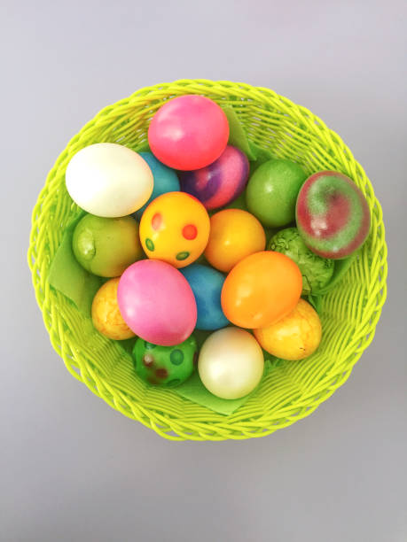 istock Multicolor Easter eggs in a basket on a wooden background. 898066796