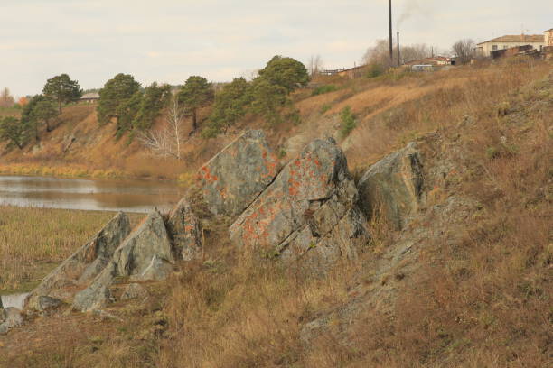 istock Stones and village on a mountain with a lake 898070772