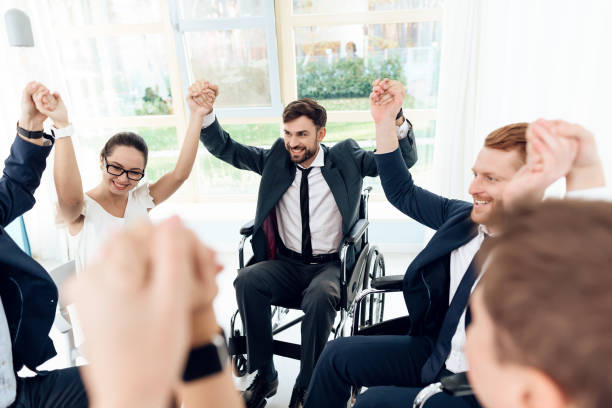 Collective work of full-fledged people and people with disabilities. Work disabled businessman.